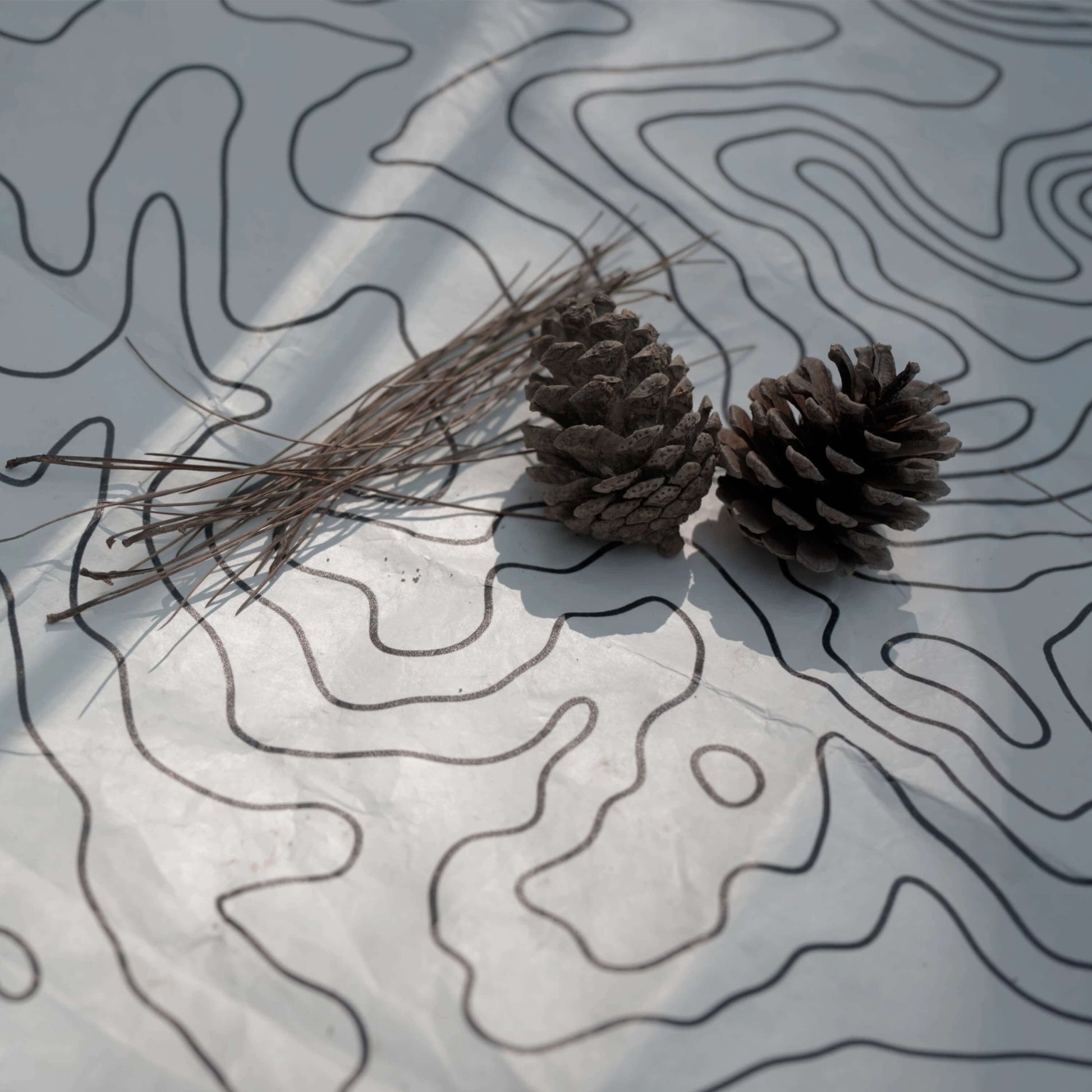 Tyvek vestibule mat with topographic pattern, pine cones & needles - HODRGEAR ultralight gear