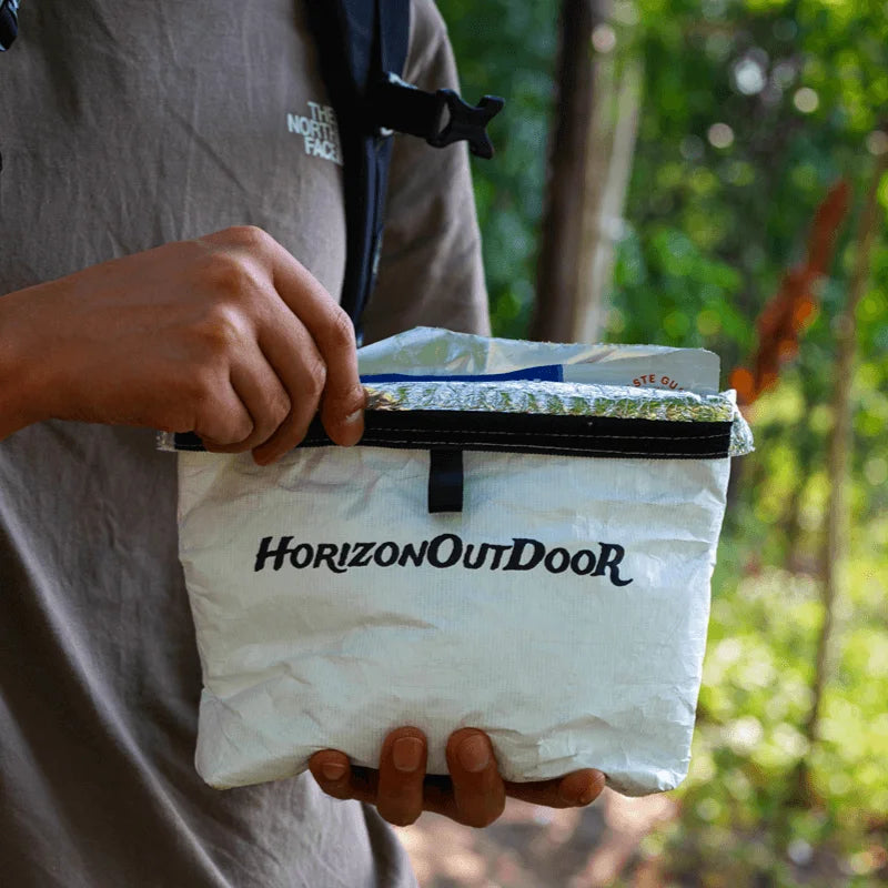 HODRGEAR 20g Tyvek insulated pouch with black zipper, hiker holding outdoors