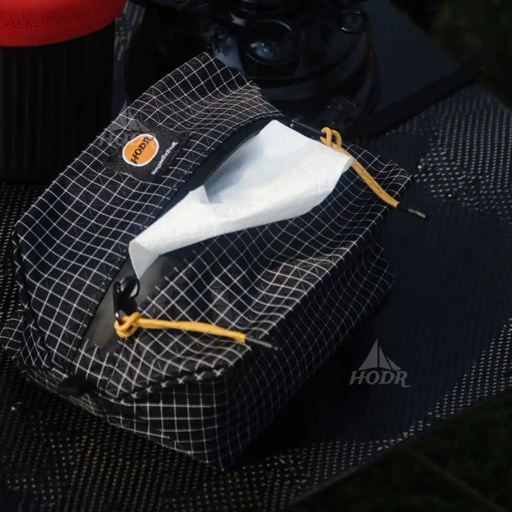 HODR Gridstop 210D zip pouch with yellow drawstrings holding tissues, ultralight hiking gear